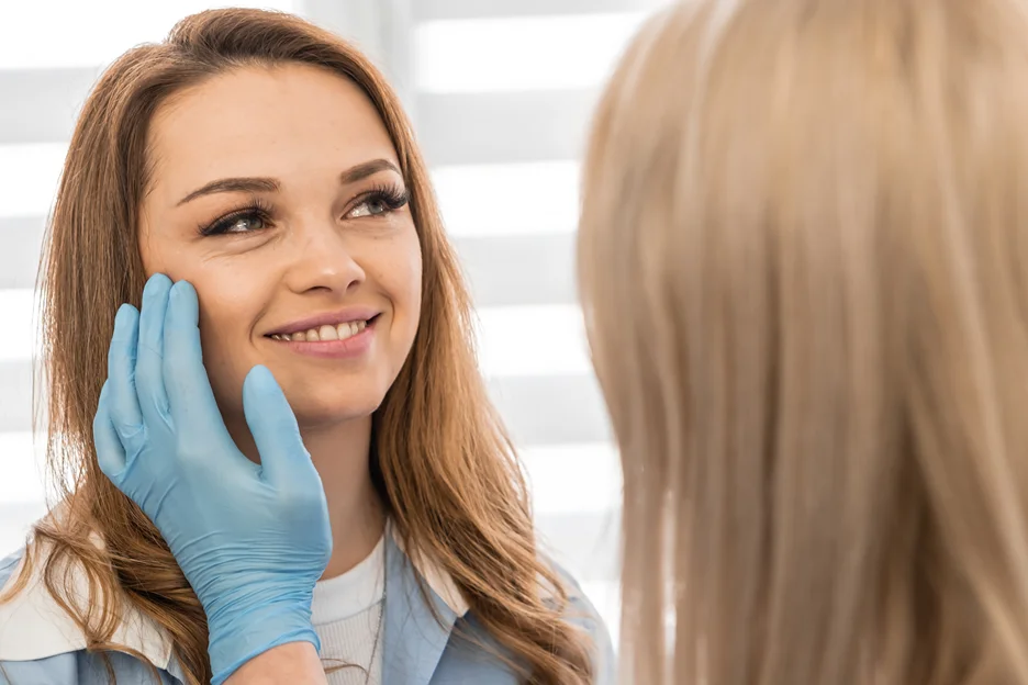 a doctor checks the patient's facial anatomy