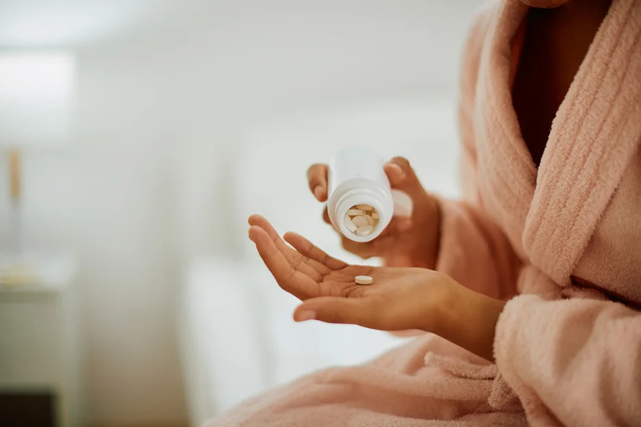 a woman taking a pill