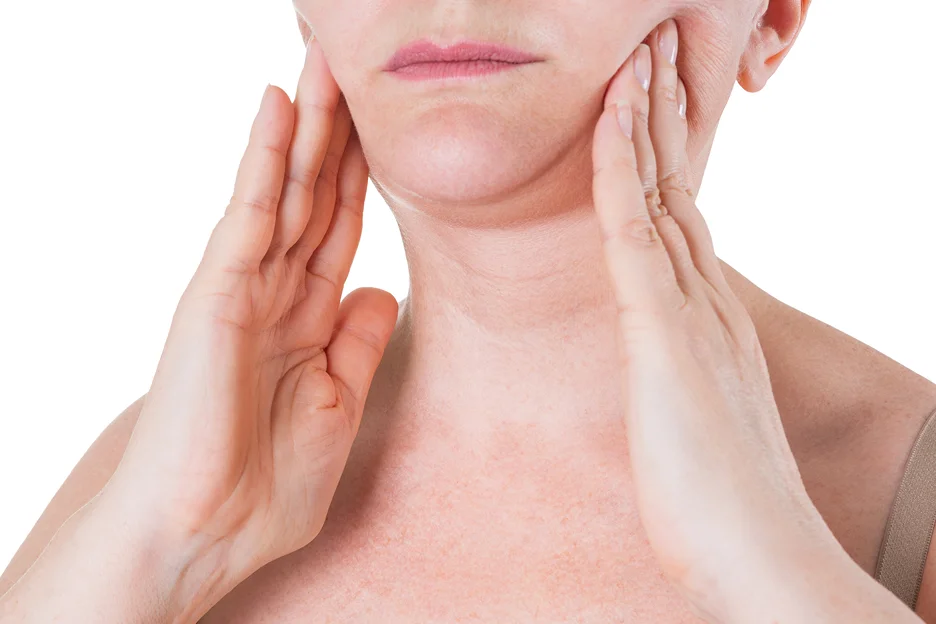 A woman is touching her slim neck with her hands.
