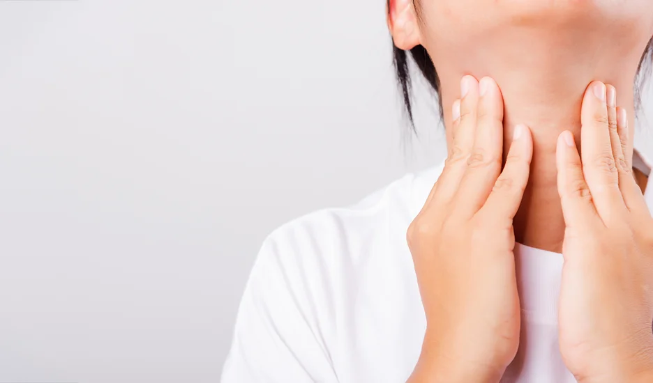 A woman is touching her neck with her hands, exploring the possibility of neck bands or considering chin liposuction as a guide.