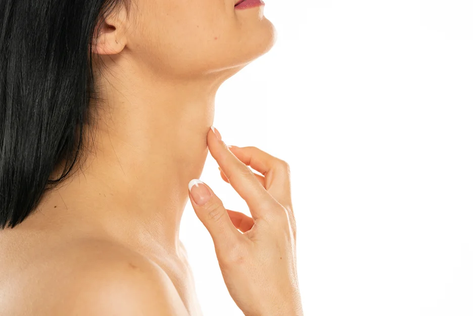 A woman showcasing the results of submental chin liposuction.