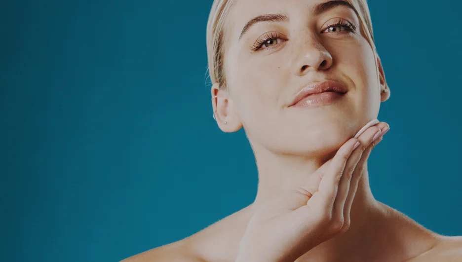 A woman is putting her hand on her sculpted look.