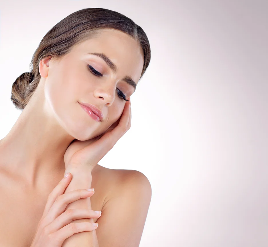 A woman is posing with her hands on her chin after a Chin Lipo recovery.