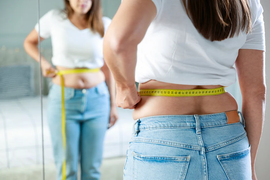 A Woman Measuring her Stomach